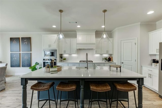 226 Montview Dr, Jefferson, GA 30549 - kitchen featuring appliances with stainless steel finishes, white cabinets, light countertops, light wood finished floors, and crown molding