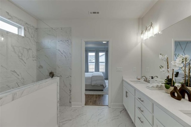 226 Montview Dr, Jefferson, GA 30549 - ensuite bathroom featuring plenty of natural light, marble look tiles, double vanity, and a walk in shower