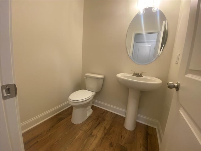 226 Montview Dr, Jefferson, GA 30549 - bathroom with wood finished floors, toilet, baseboards, and a sink
