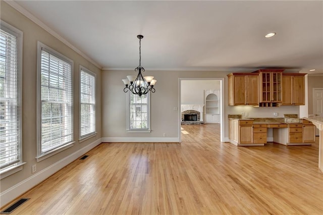 870 Longstone Lndg, Alpharetta, GA 30022 - kitchen with ornamental molding, a chandelier, light wood-type flooring, light countertops, and glass insert cabinets