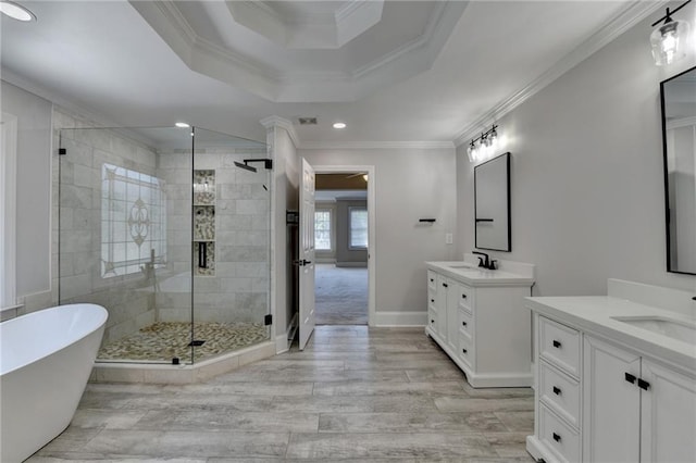 870 Longstone Lndg, Alpharetta, GA 30022 - full bathroom with a stall shower, two vanities, a freestanding bath, a tray ceiling, and wood finished floors