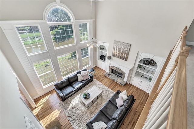 870 Longstone Lndg, Alpharetta, GA 30022 - living area with a towering ceiling, a fireplace, wood finished floors, and ceiling fan