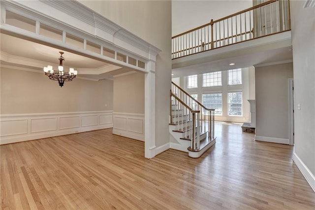 870 Longstone Lndg, Alpharetta, GA 30022 - empty room featuring wood finished floors, a chandelier, crown molding, a towering ceiling, and stairway