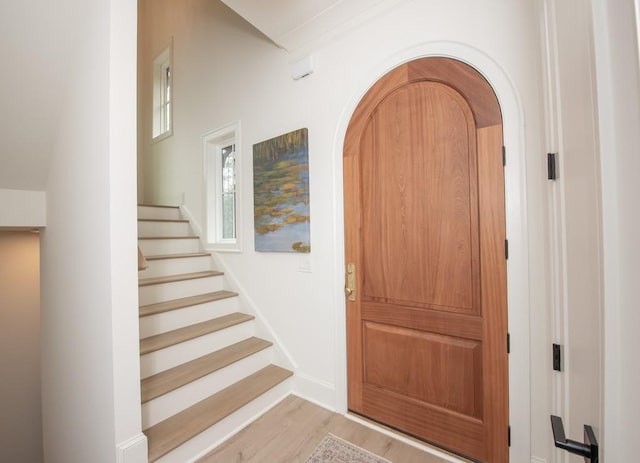 6 Huntington Pl, Dahlonega, GA 30533 - entrance foyer with light wood finished floors, stairway, and arched walkways