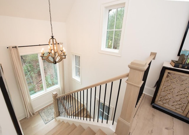 6 Huntington Pl, Dahlonega, GA 30533 - staircase featuring a chandelier, wood finished floors, plenty of natural light, baseboards, and lofted ceiling