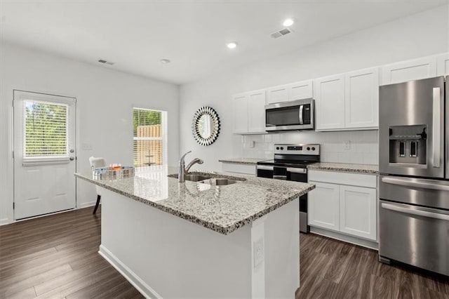 kitchen featuring appliances with stainless steel finishes, dark hardwood / wood-style floors, decorative backsplash, and sink