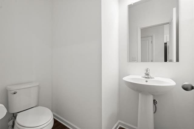 bathroom featuring toilet and hardwood / wood-style floors