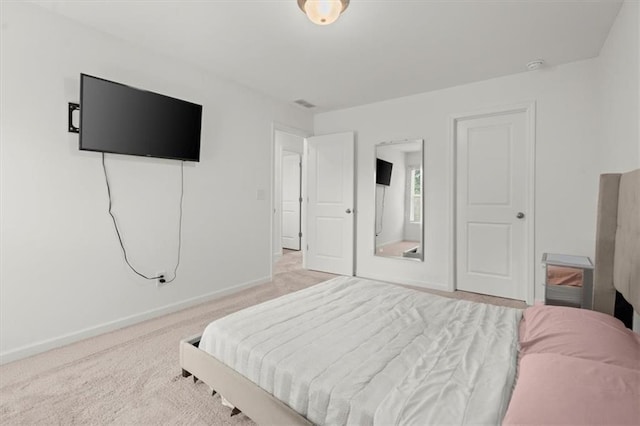 bedroom with light colored carpet