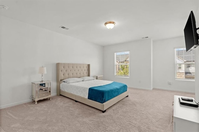 carpeted bedroom featuring multiple windows