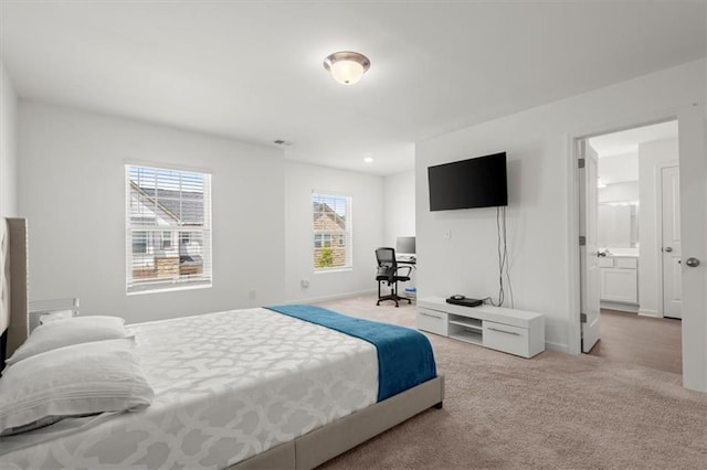 carpeted bedroom featuring ensuite bathroom