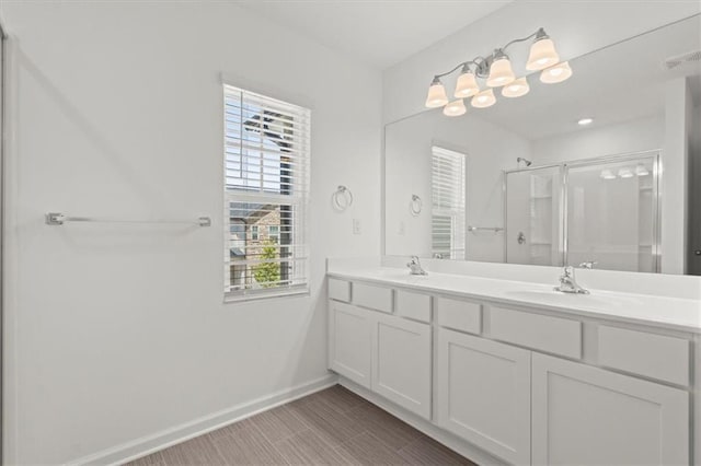 bathroom with tile patterned flooring, an enclosed shower, and vanity