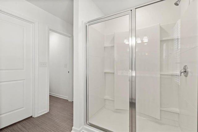 bathroom featuring an enclosed shower and tile patterned floors