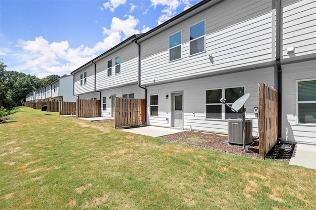 rear view of house featuring a lawn and a patio area