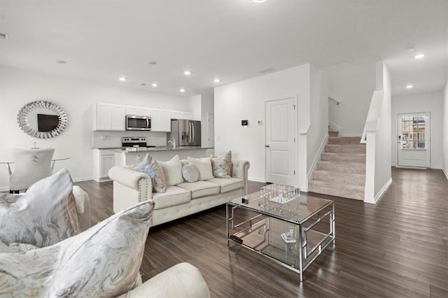 living room with dark wood-type flooring and sink