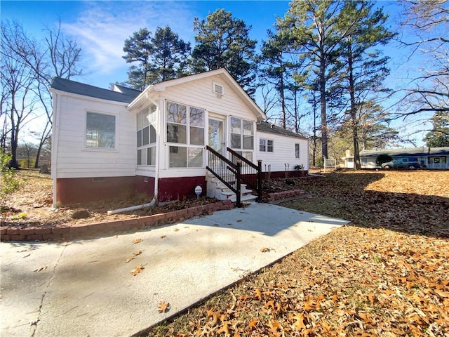 view of front of house featuring a sunroom