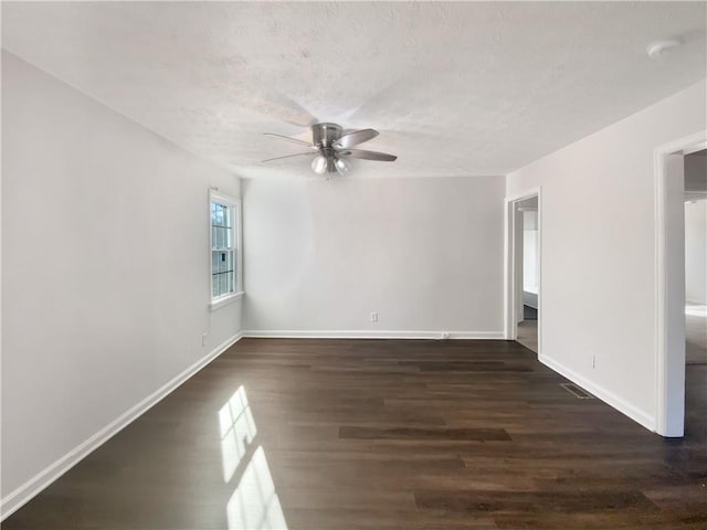 empty room featuring ceiling fan and dark hardwood / wood-style flooring