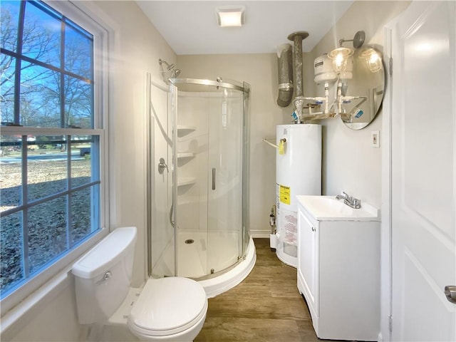 bathroom featuring gas water heater, hardwood / wood-style floors, toilet, a shower with door, and vanity