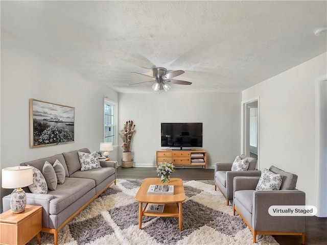 living room featuring hardwood / wood-style flooring and ceiling fan