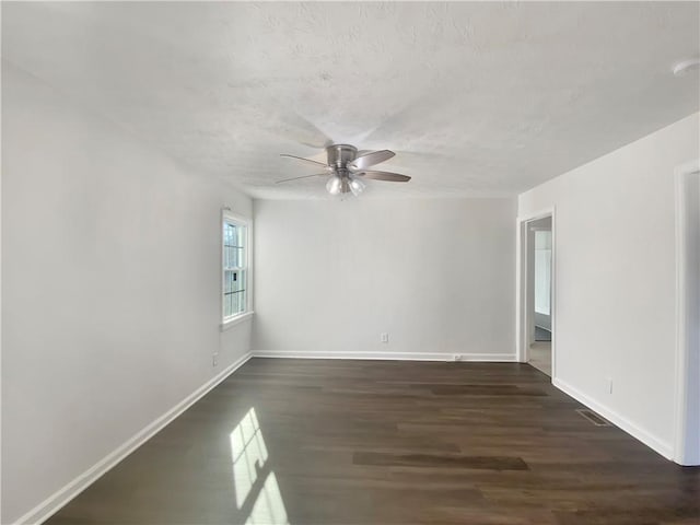 spare room featuring dark hardwood / wood-style flooring and ceiling fan