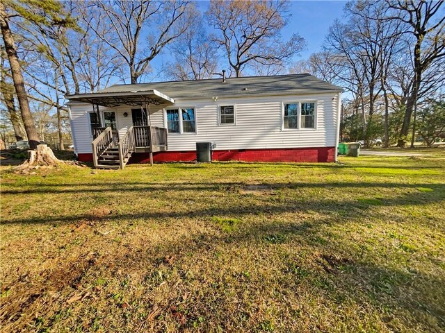 rear view of house featuring a lawn