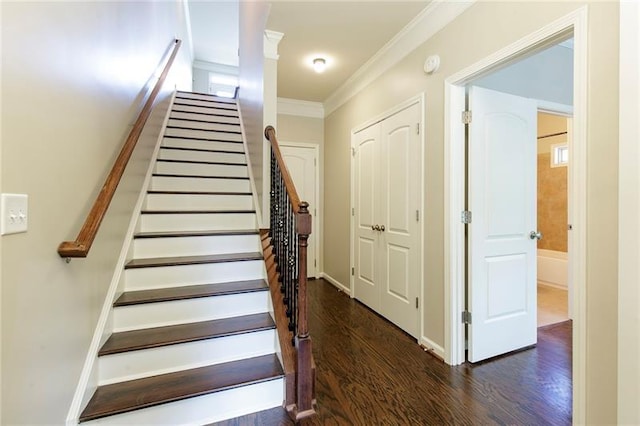 staircase with crown molding and hardwood / wood-style flooring