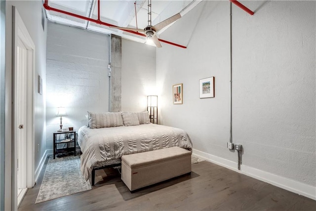 bedroom with wood finished floors and baseboards