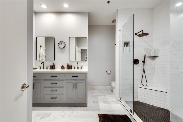 full bathroom with double vanity, a sink, toilet, and a shower stall