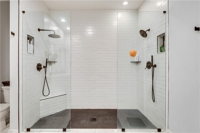 bathroom featuring toilet and a walk in shower