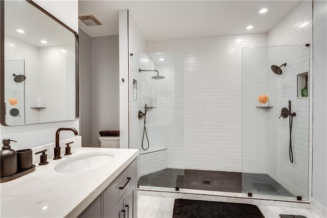 full bathroom featuring recessed lighting, visible vents, toilet, vanity, and a walk in shower