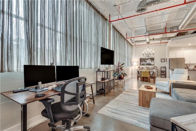 home office featuring an inviting chandelier