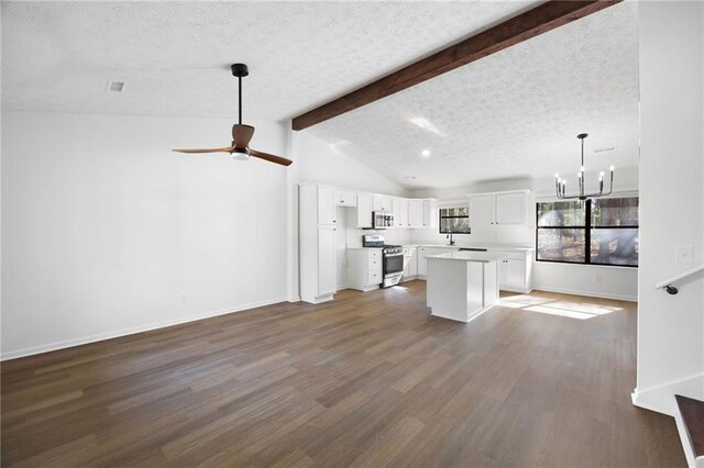 kitchen featuring open floor plan, appliances with stainless steel finishes, dark wood-style floors, white cabinets, and a textured ceiling