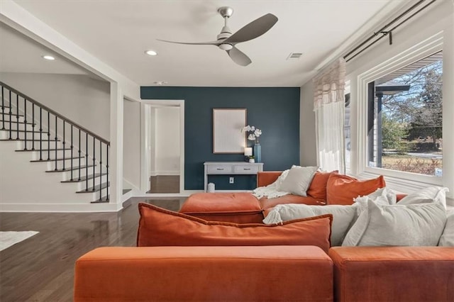 living room with stairs, ceiling fan, wood finished floors, and baseboards