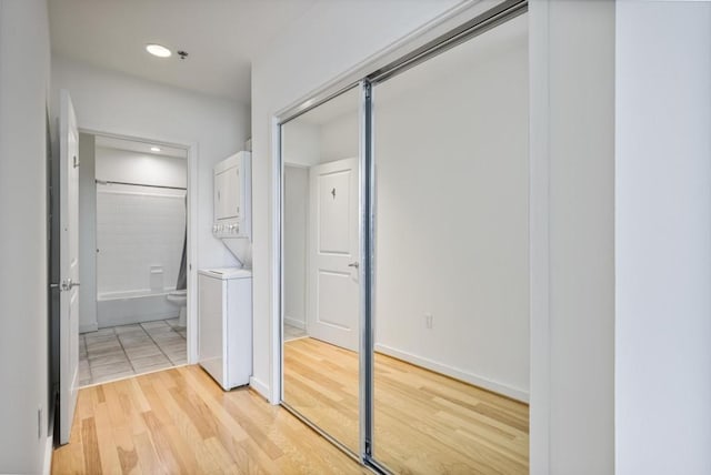 943 Peachtree St NE Unit 716, Atlanta, GA 30309 - corridor with stacked washer and clothes dryer, light wood-type flooring, and recessed lighting