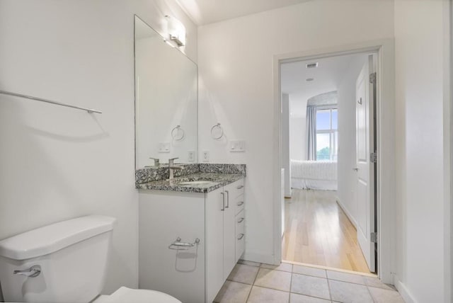 943 Peachtree St NE Unit 716, Atlanta, GA 30309 - bathroom with toilet, vanity, tile patterned flooring, and baseboards