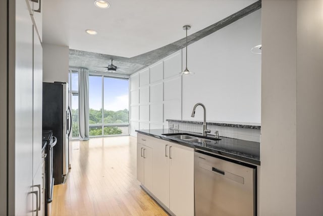 943 Peachtree St NE Unit 716, Atlanta, GA 30309 - kitchen with appliances with stainless steel finishes, a sink, light wood finished floors, recessed lighting, and decorative light fixtures