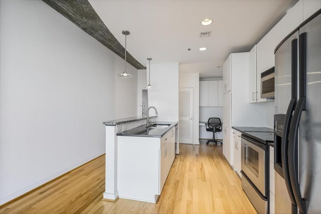 943 Peachtree St NE Unit 716, Atlanta, GA 30309 - kitchen with stainless steel appliances, a sink, light wood-type flooring, dark countertops, and recessed lighting