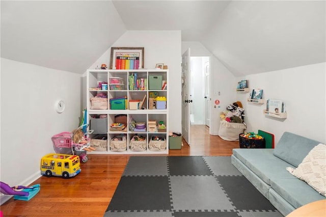 recreation room with hardwood / wood-style flooring and vaulted ceiling