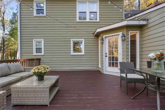 wooden terrace with outdoor lounge area