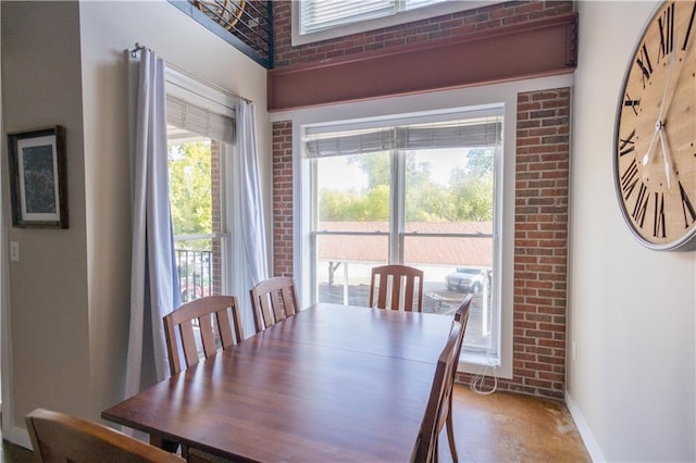 dining room with brick wall