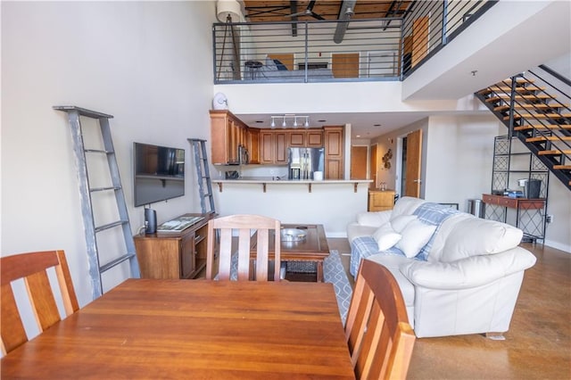 dining area with a towering ceiling