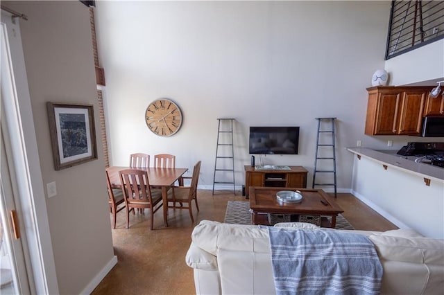 carpeted living room with a towering ceiling