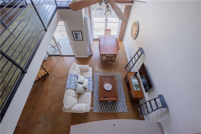 living room featuring a towering ceiling and ceiling fan