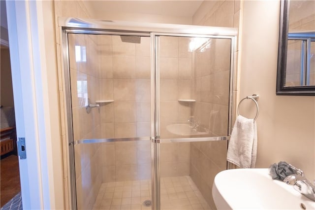 bathroom with walk in shower and sink