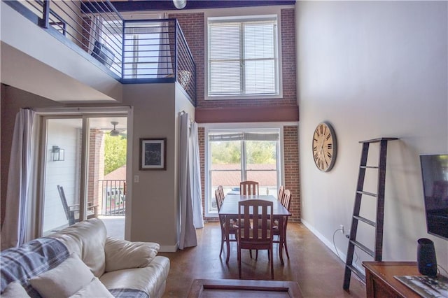 living room with a towering ceiling and concrete flooring