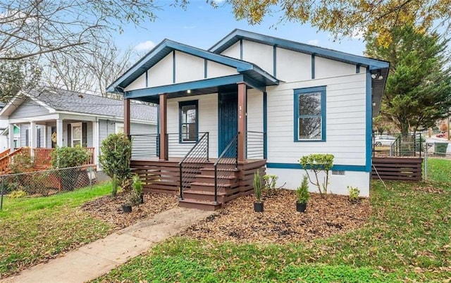 bungalow featuring crawl space, a porch, a front lawn, and fence