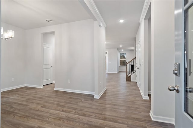 hallway with dark hardwood / wood-style flooring and a chandelier