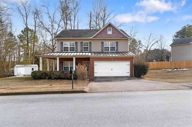 view of front of property with a porch, a storage unit, and a garage