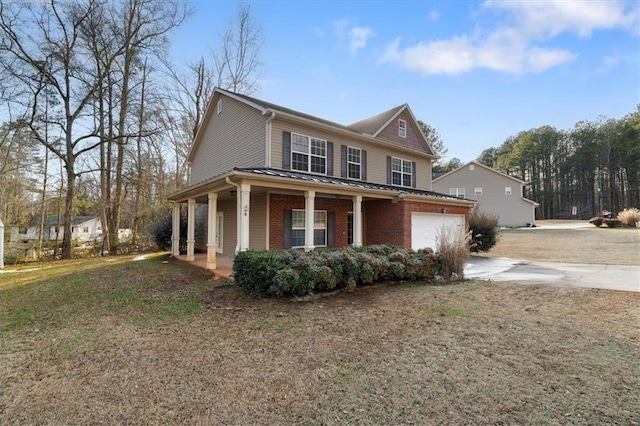 view of side of property featuring a garage and covered porch