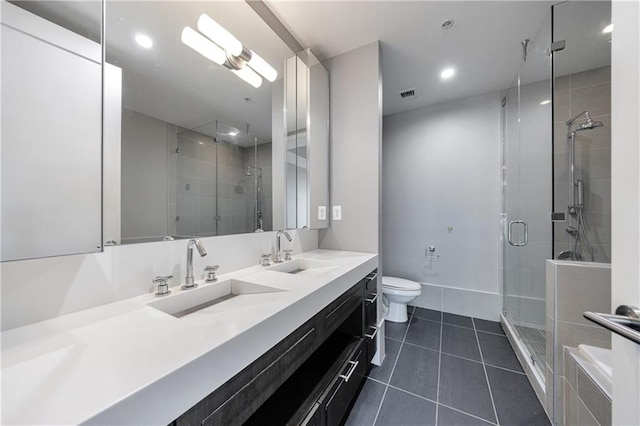 full bath with a sink, a shower stall, and tile patterned floors