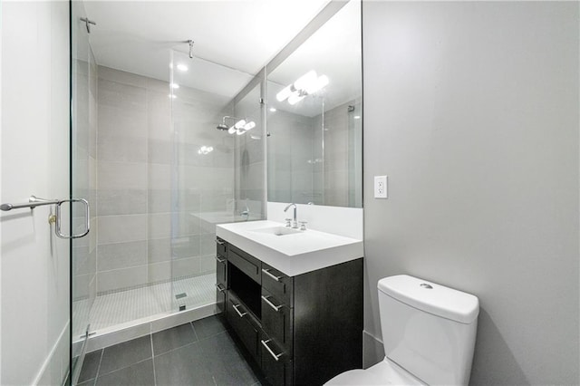 full bath featuring a stall shower, vanity, toilet, and tile patterned floors